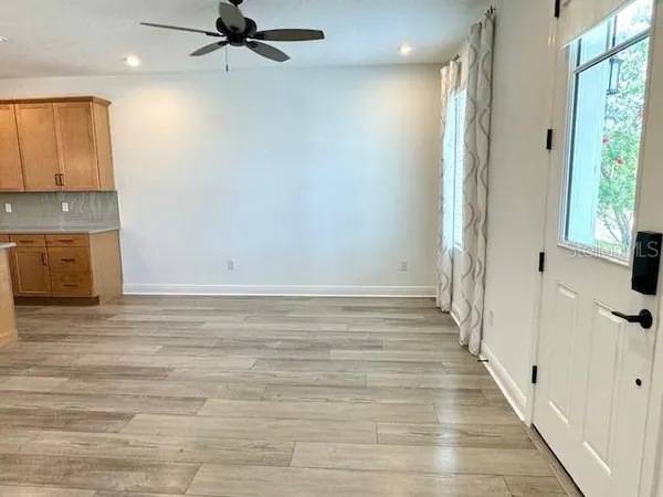a view of a hallway to a house and wooden floor
