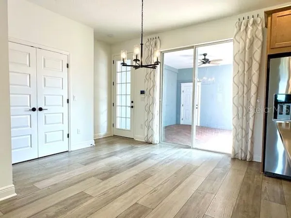 a view of empty room with wooden floor and a fireplace