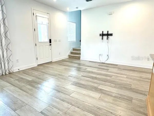 a view of a room with wooden floor
