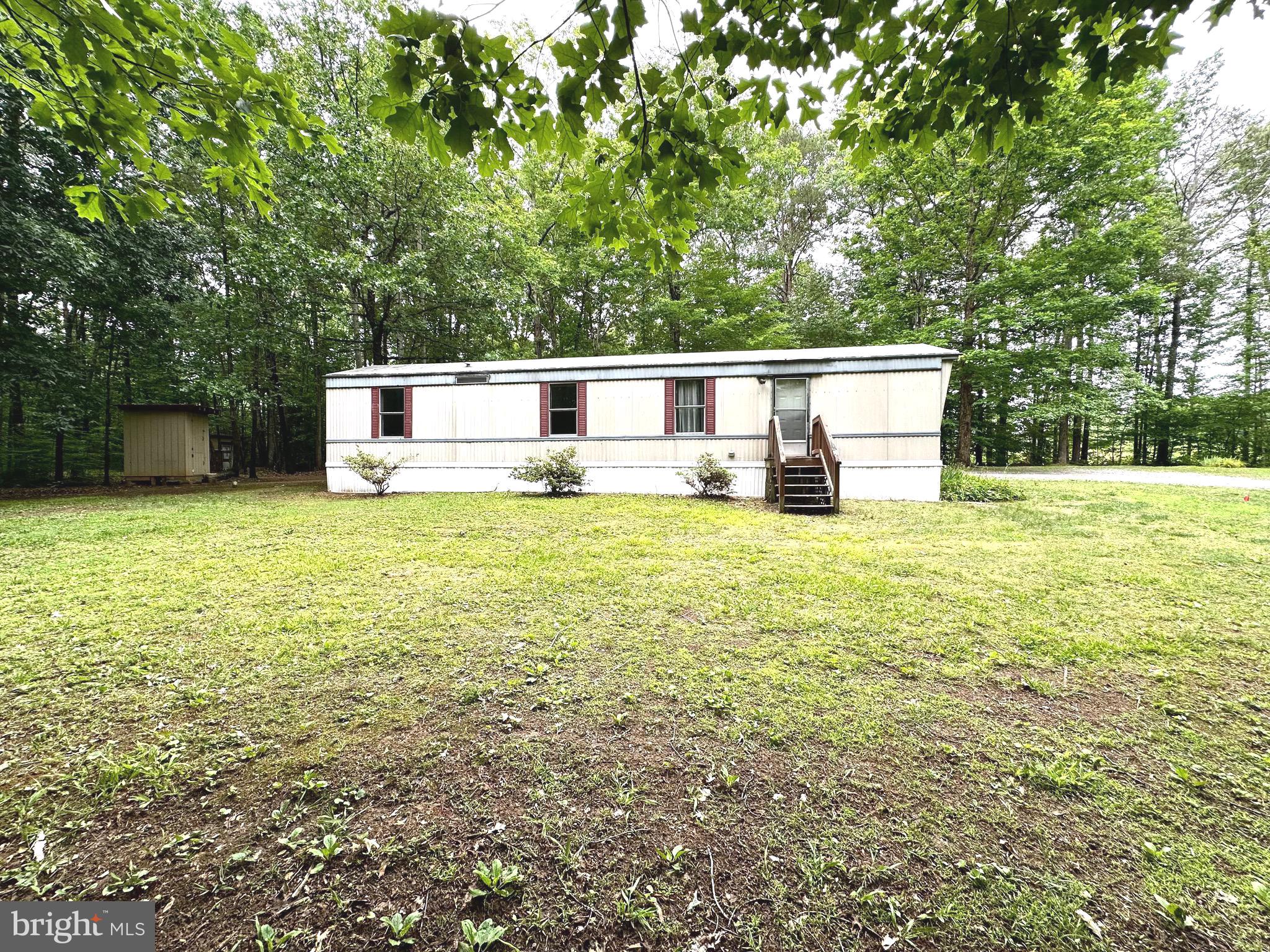 606 Dogwood Acres Road Bumpass, VA 23024 - Photo 2 of 20 a swimming pool with lawn chairs and trees