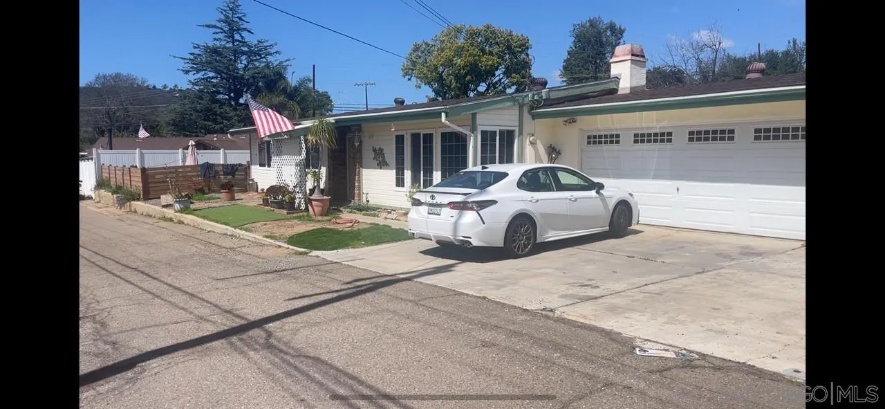 a white house that has a tree in front of it