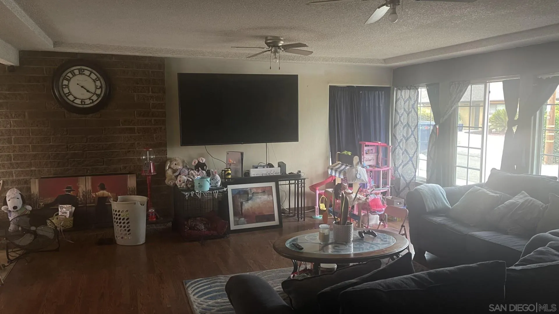 12378 Wade Way El Cajon, CA 92021 - Photo 8 of 13 a living room with furniture a flat screen tv and a clock
