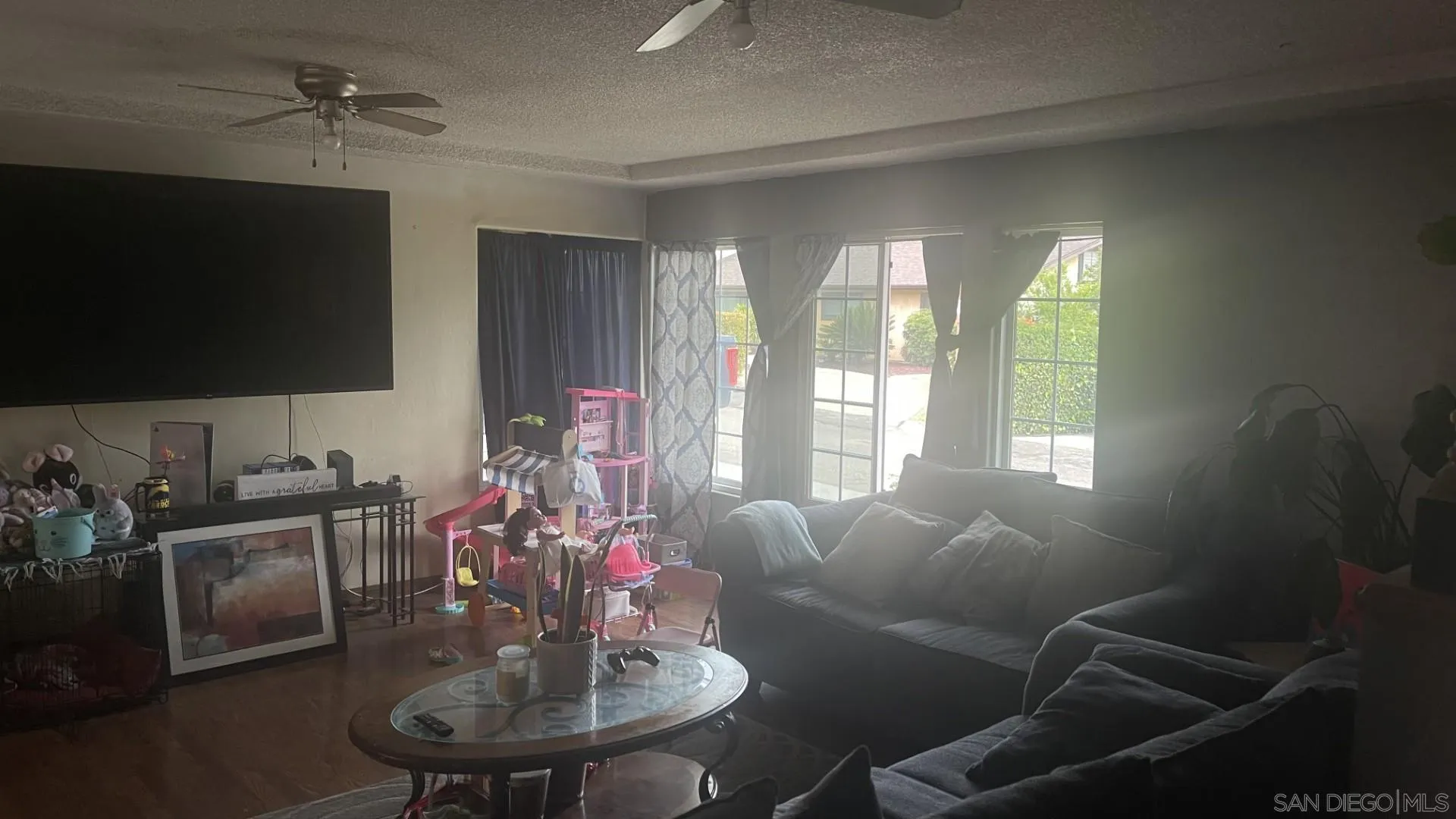 12378 Wade Way El Cajon, CA 92021 - Photo 9 of 13 a living room with furniture and a flat screen tv