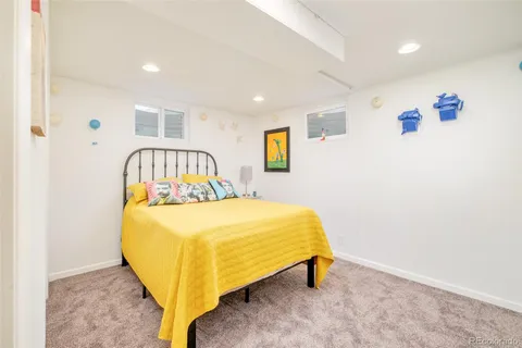 a bed sitting in a room next to a window