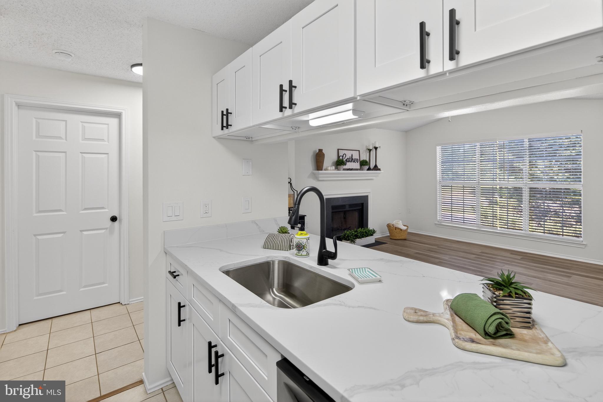 21009 Timber Ridge Terrace, Unit 203 Ashburn, VA 20147 - Photo 3 of 38 Modern kitchen with bright accents.