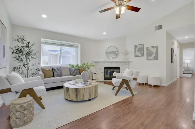 a living room with furniture and a fireplace