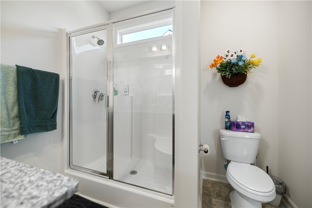 104 Village Main Anderson, SC 29621 - Photo 16 of 32 This clean and functional bathroom features a shower with a clear glass enclosure and a comfortable toilet.