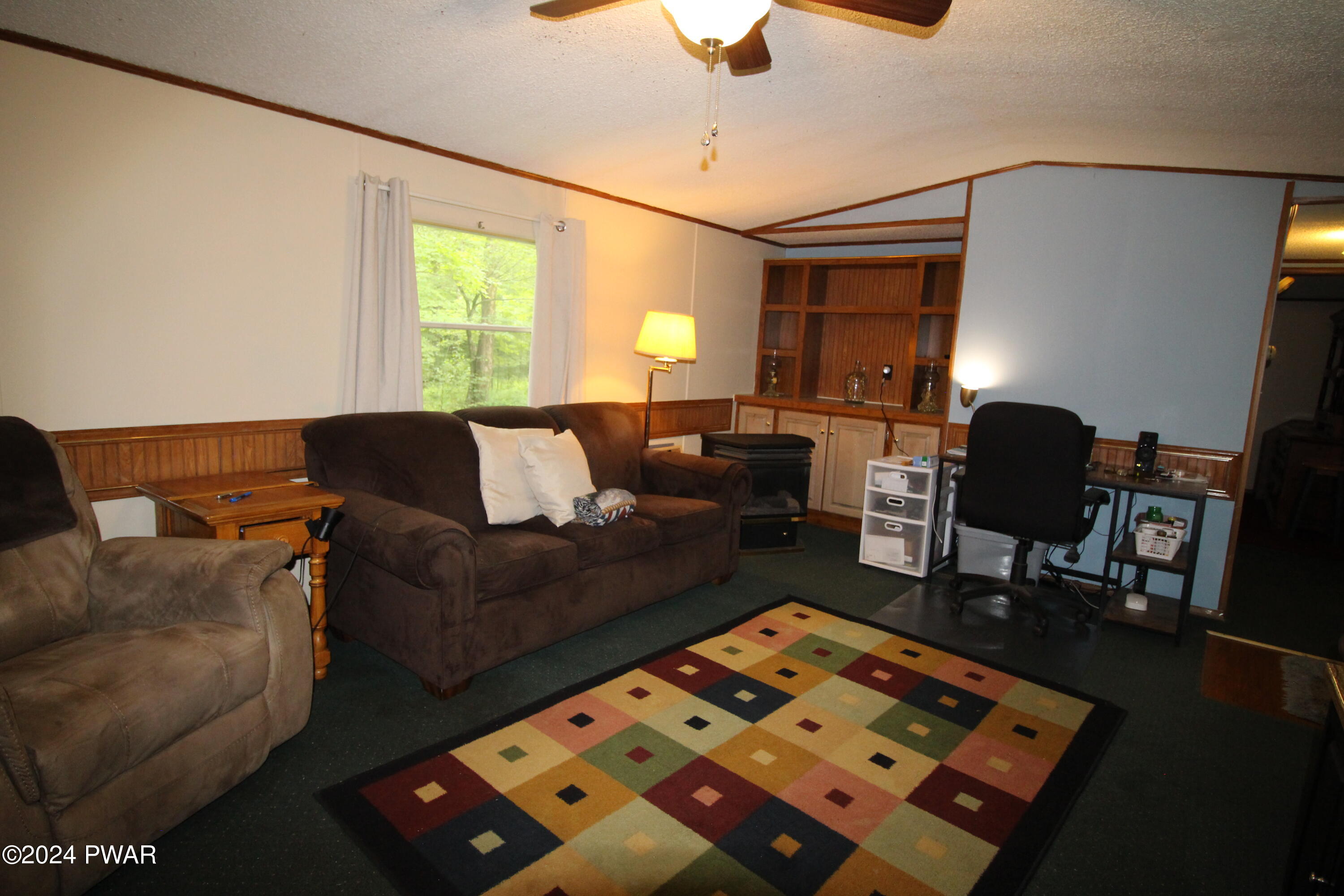 10 Madison Estate Moscow, PA 18444 - Photo 10 of 45 a living room with furniture and a lamp