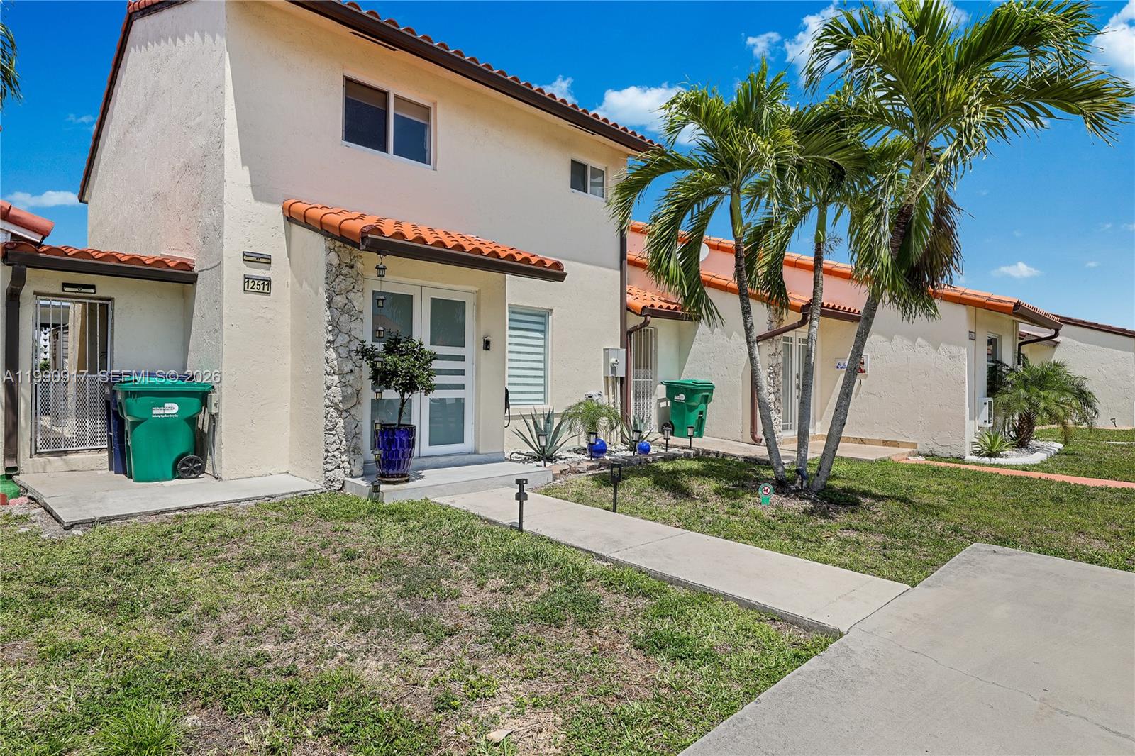 12511 Southwest 12th Lane Miami, FL 33184 - Photo 1 of 20 a front view of a house with garden and patio