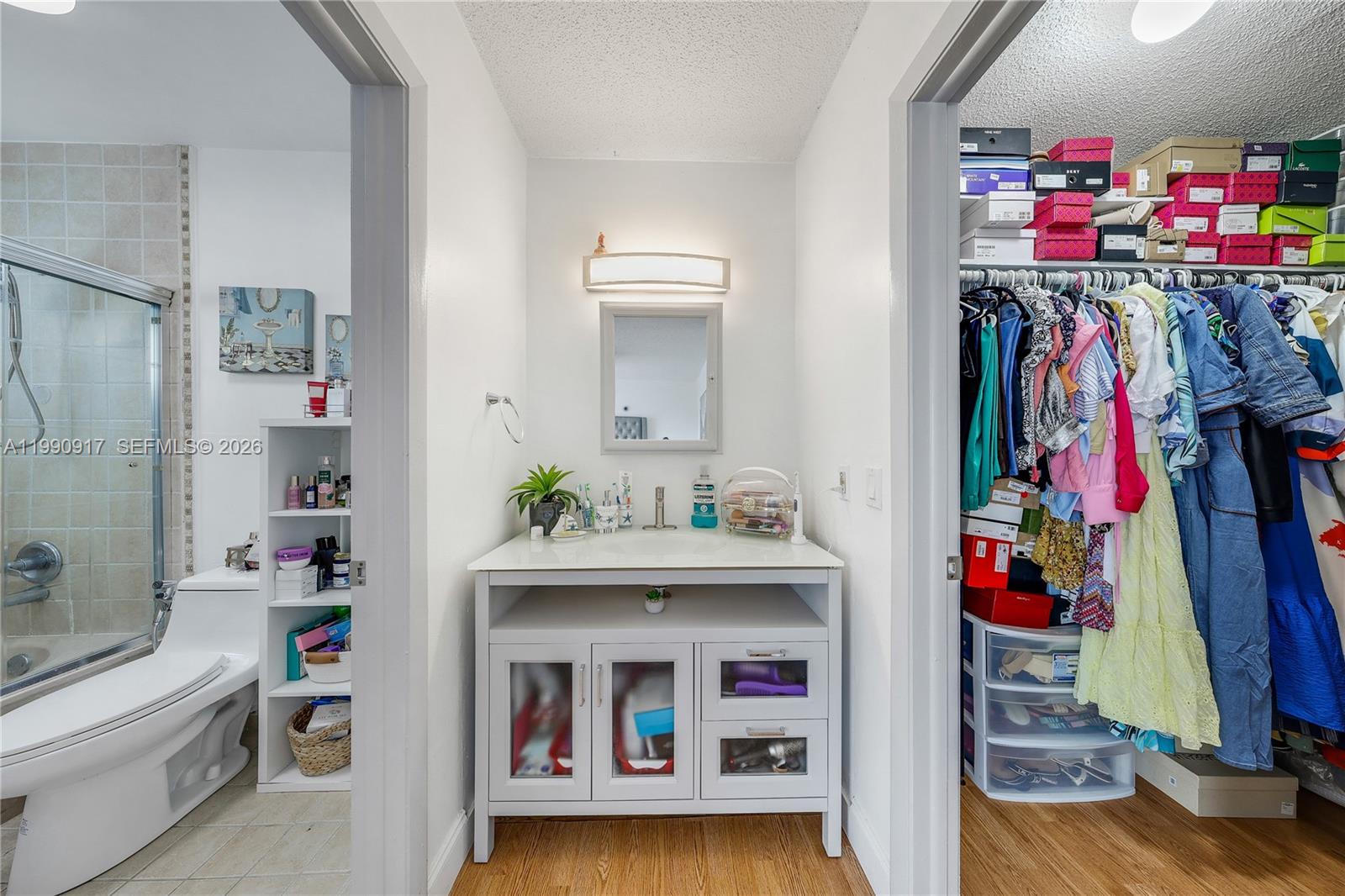 12511 Southwest 12th Lane Miami, FL 33184 - Photo 11 of 20 a view of walk in closet with clothes and shoes