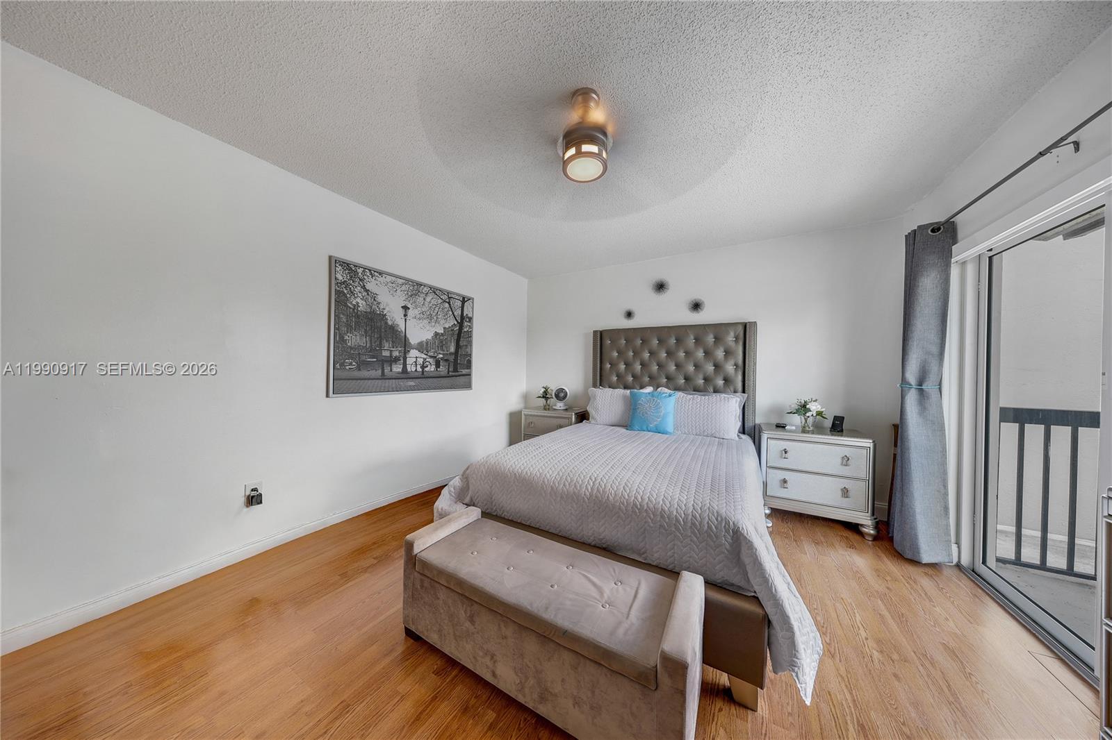 12511 Southwest 12th Lane Miami, FL 33184 - Photo 12 of 20 a bedroom with a bed and a chandelier