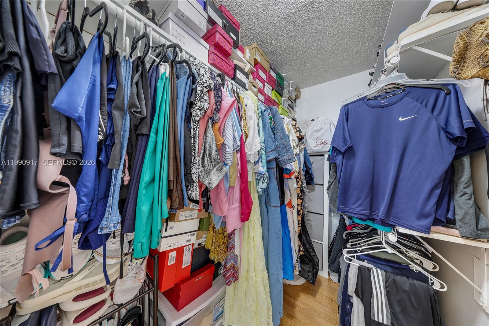 12511 Southwest 12th Lane Miami, FL 33184 - Photo 13 of 20 a view of walk in closet with clothes