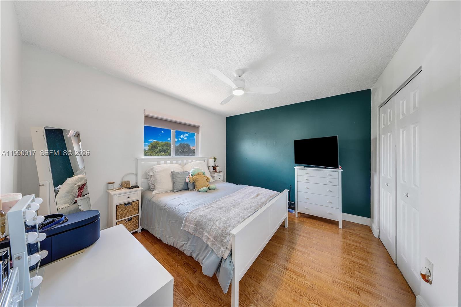 12511 Southwest 12th Lane Miami, FL 33184 - Photo 14 of 20 a bedroom with a bed and a flat screen tv
