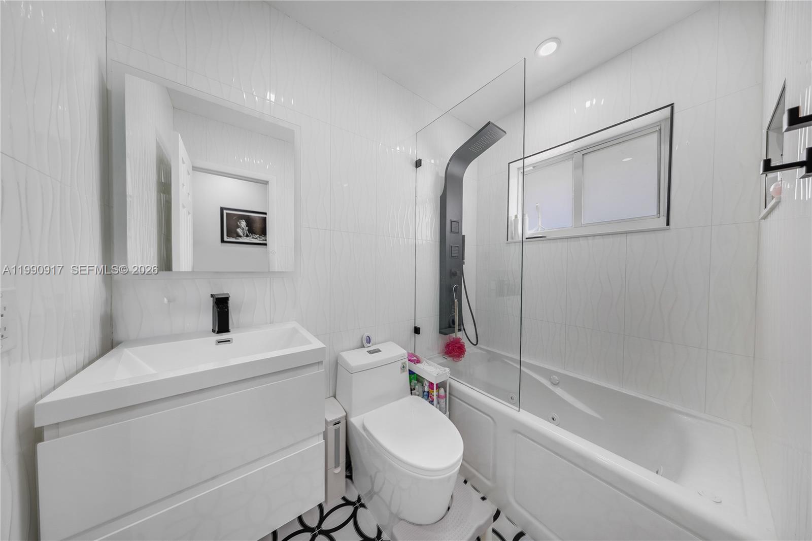12511 Southwest 12th Lane Miami, FL 33184 - Photo 15 of 20 a bathroom with a sink toilet and shower