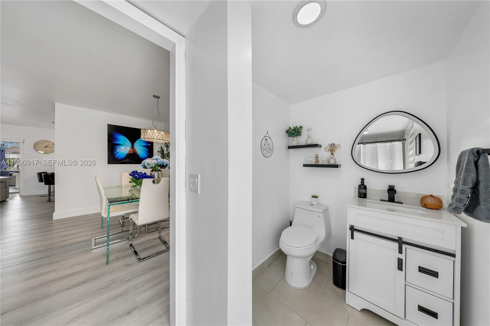 12511 Southwest 12th Lane Miami, FL 33184 - Photo 4 of 20 a bathroom with a toilet a sink and a mirror
