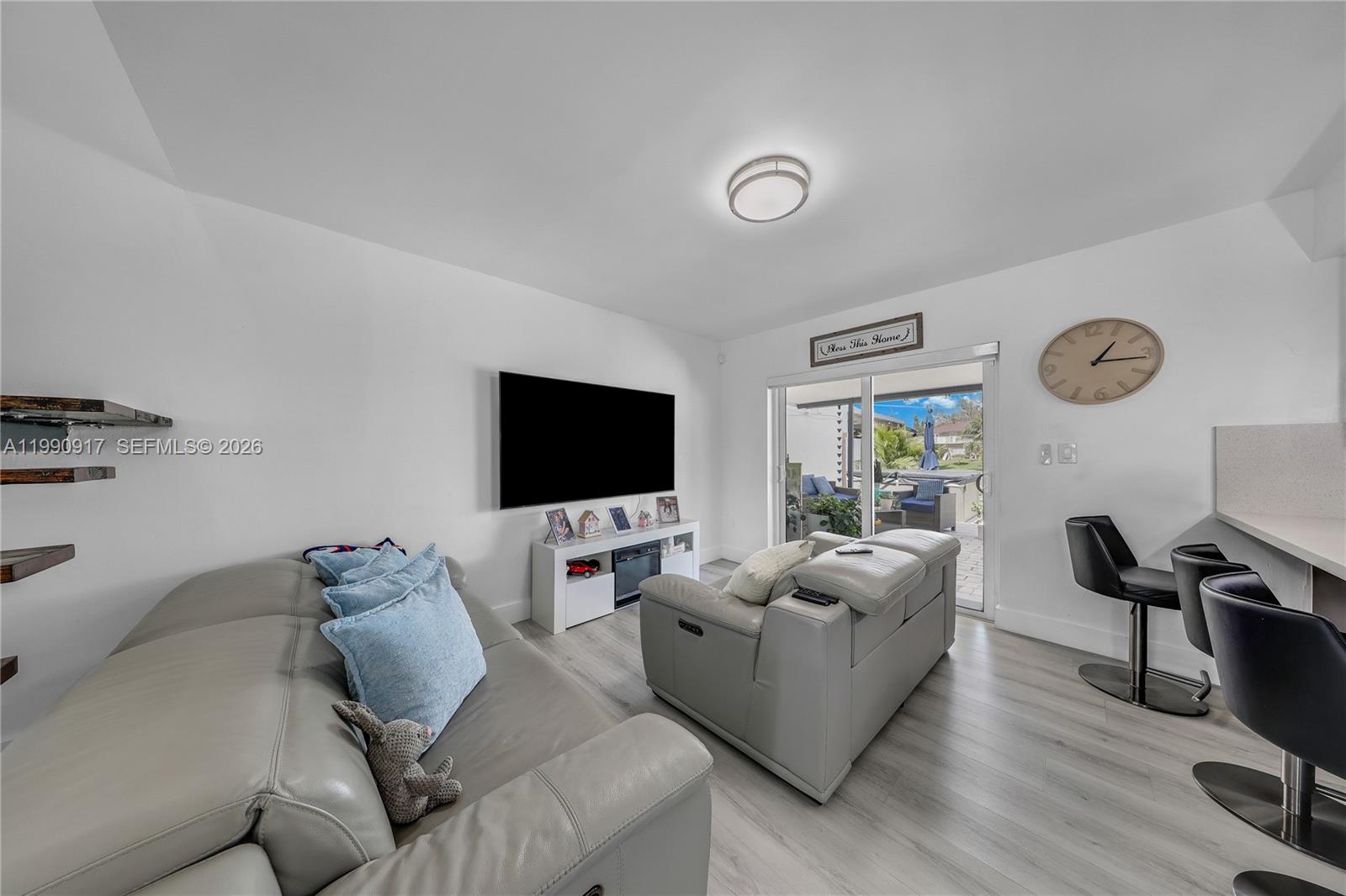 12511 Southwest 12th Lane Miami, FL 33184 - Photo 6 of 20 a living room with furniture and a flat screen tv