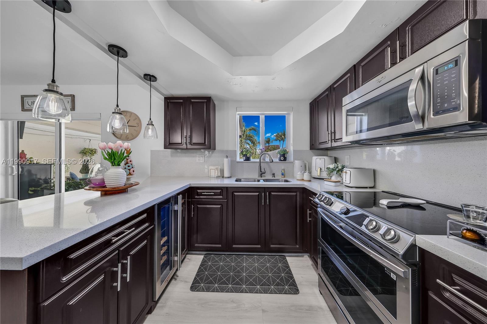 12511 Southwest 12th Lane Miami, FL 33184 - Photo 8 of 20 a kitchen with stainless steel appliances a sink a stove cabinets and a counter top space