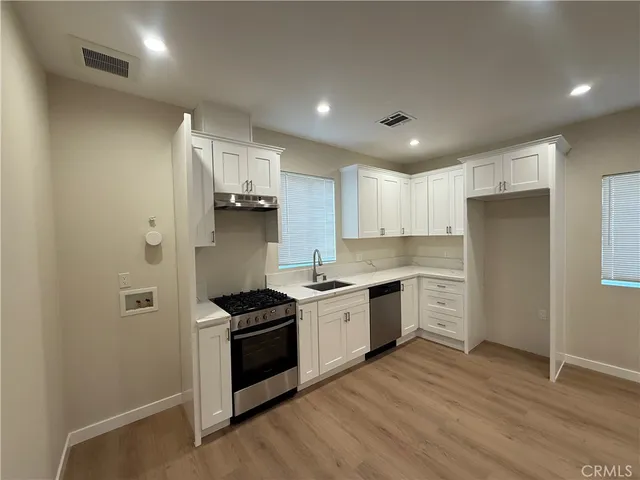 a kitchen with stainless steel appliances granite countertop a stove and a refrigerator