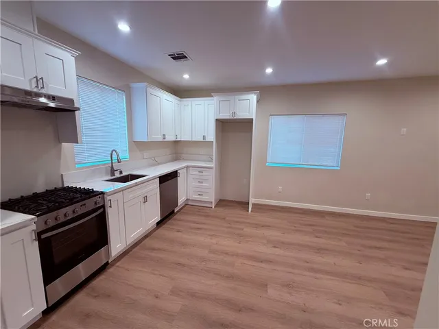a kitchen with granite countertop a stove and a refrigerator