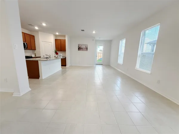 a view of kitchen with stove and cabinets
