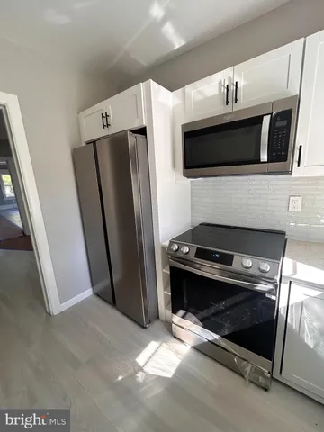a white bath tub sitting next to a white sink
