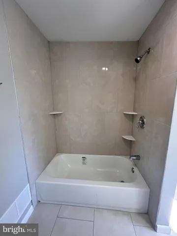 a bathroom with a bathtub and toilet