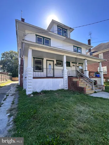 a view of a house with a yard porch and sitting area