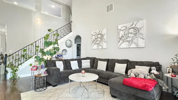 a living room with furniture and wooden floor
