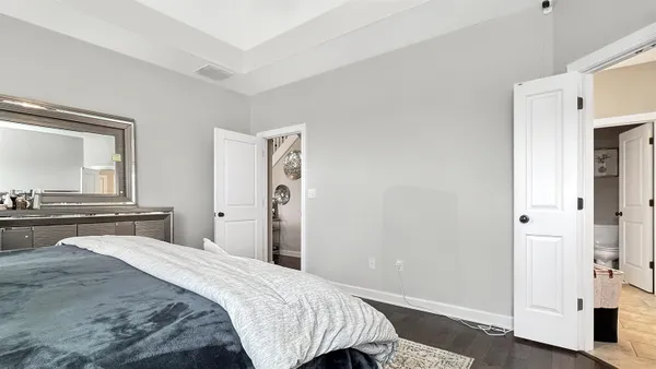 a bedroom with a bed and a large mirror