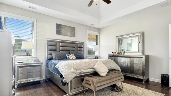 a bedroom with a bed and a chandelier