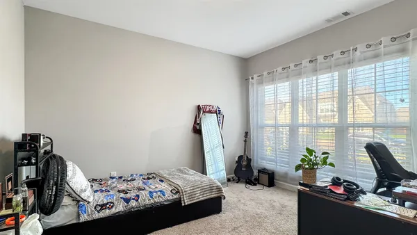 a bedroom with a bed furniture and a window