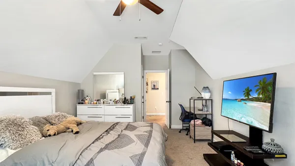 a bedroom with furniture and a flat screen tv