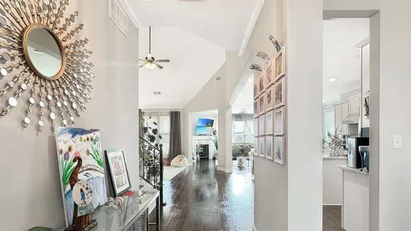 a view of entryway and hall with wooden floor