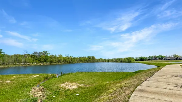 a view of a lake with houses in the back