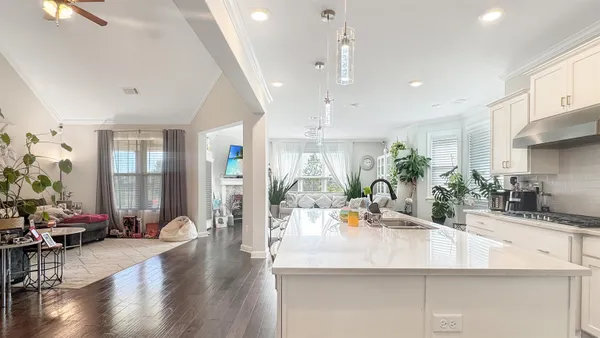 a kitchen with counter top space and living room view
