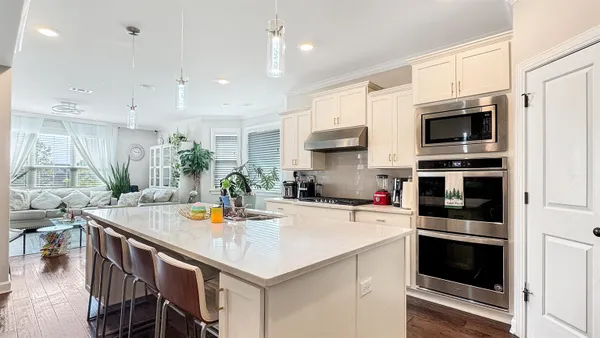 a kitchen with a stove a microwave and a refrigerator