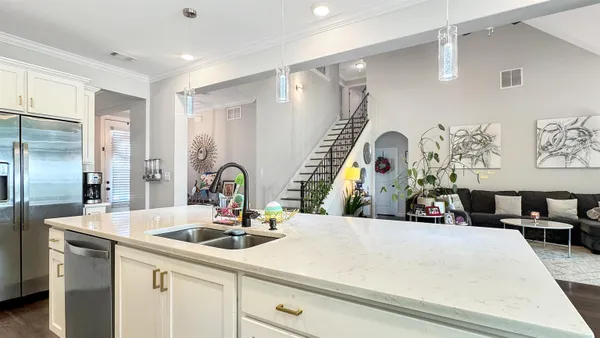 a kitchen with kitchen island a sink appliances and a counter top space