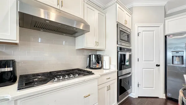 a kitchen with stainless steel appliances granite countertop a stove and a refrigerator