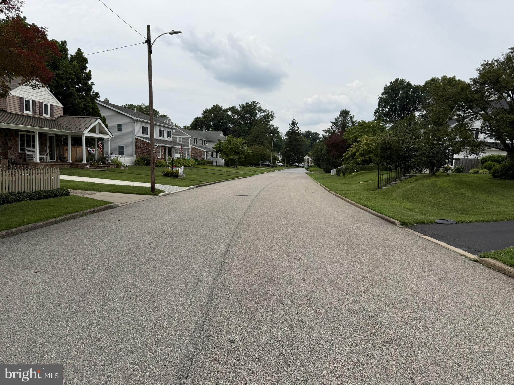 217 Lyster Road Oreland, PA 19075 - Photo 10 of 11 Quiet suburban street in summer.