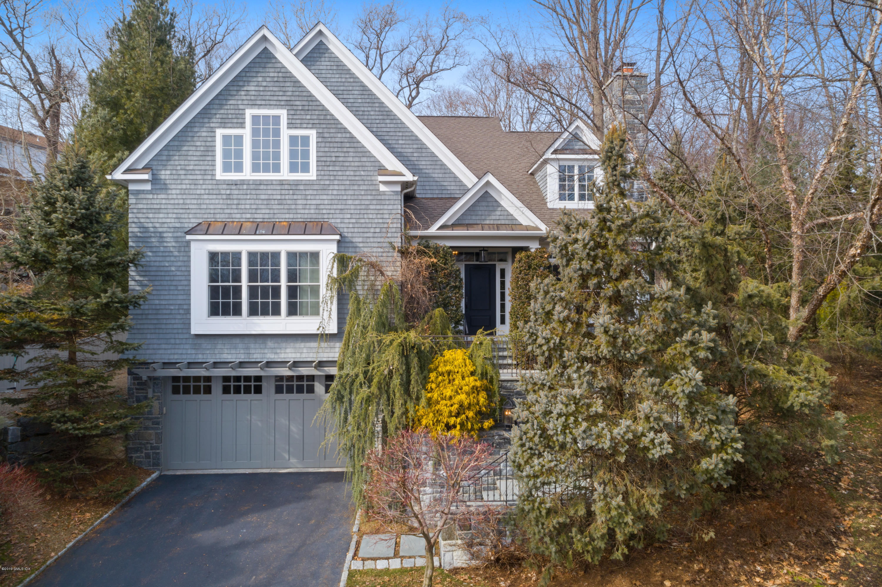 340 Valley Road, Unit 5 Cos Cob, CT 06807 - Photo 1 of 29 a front view of a house with a yard and garage