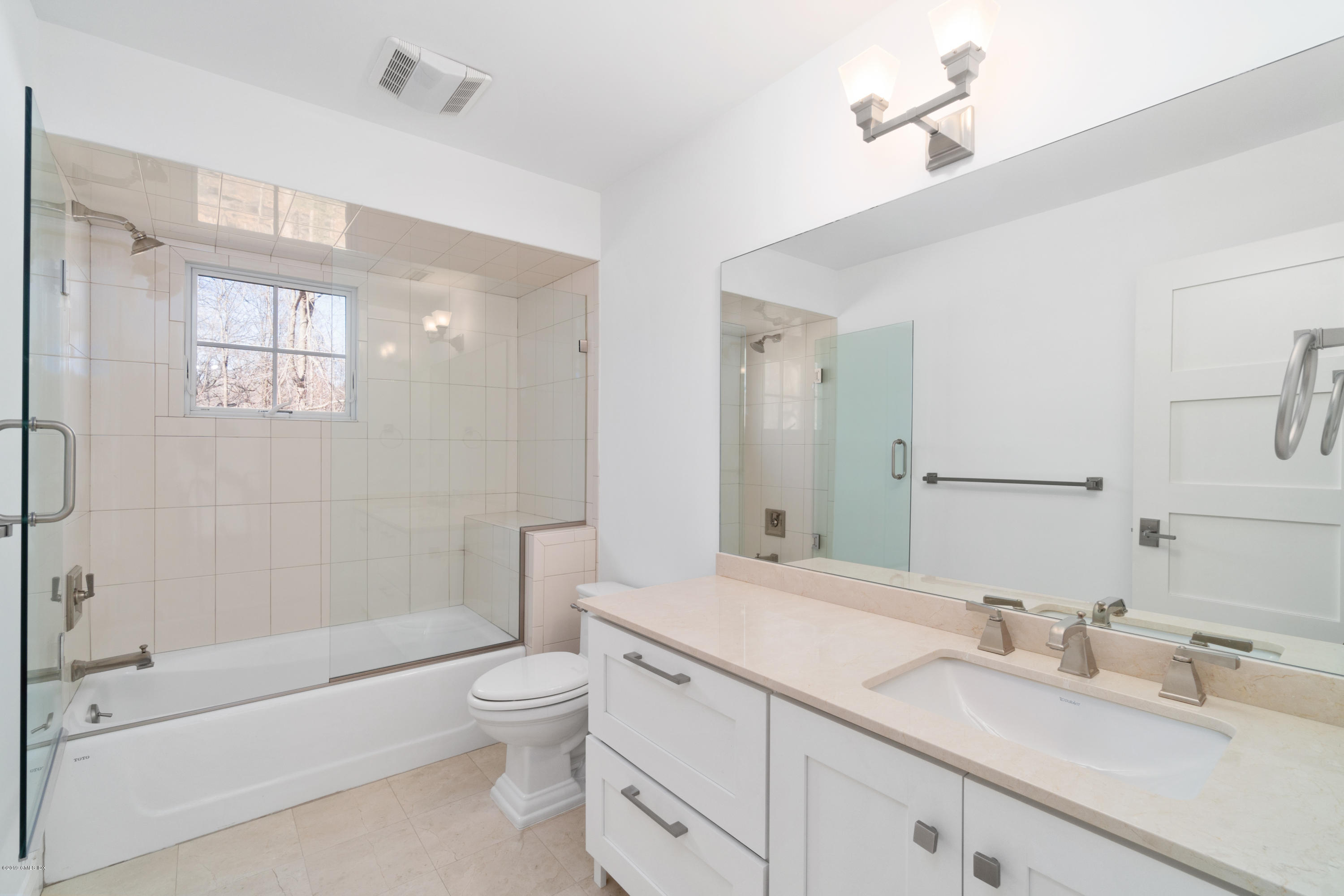340 Valley Road, Unit 5 Cos Cob, CT 06807 - Photo 15 of 29 a bathroom with a granite countertop sink a toilet and shower