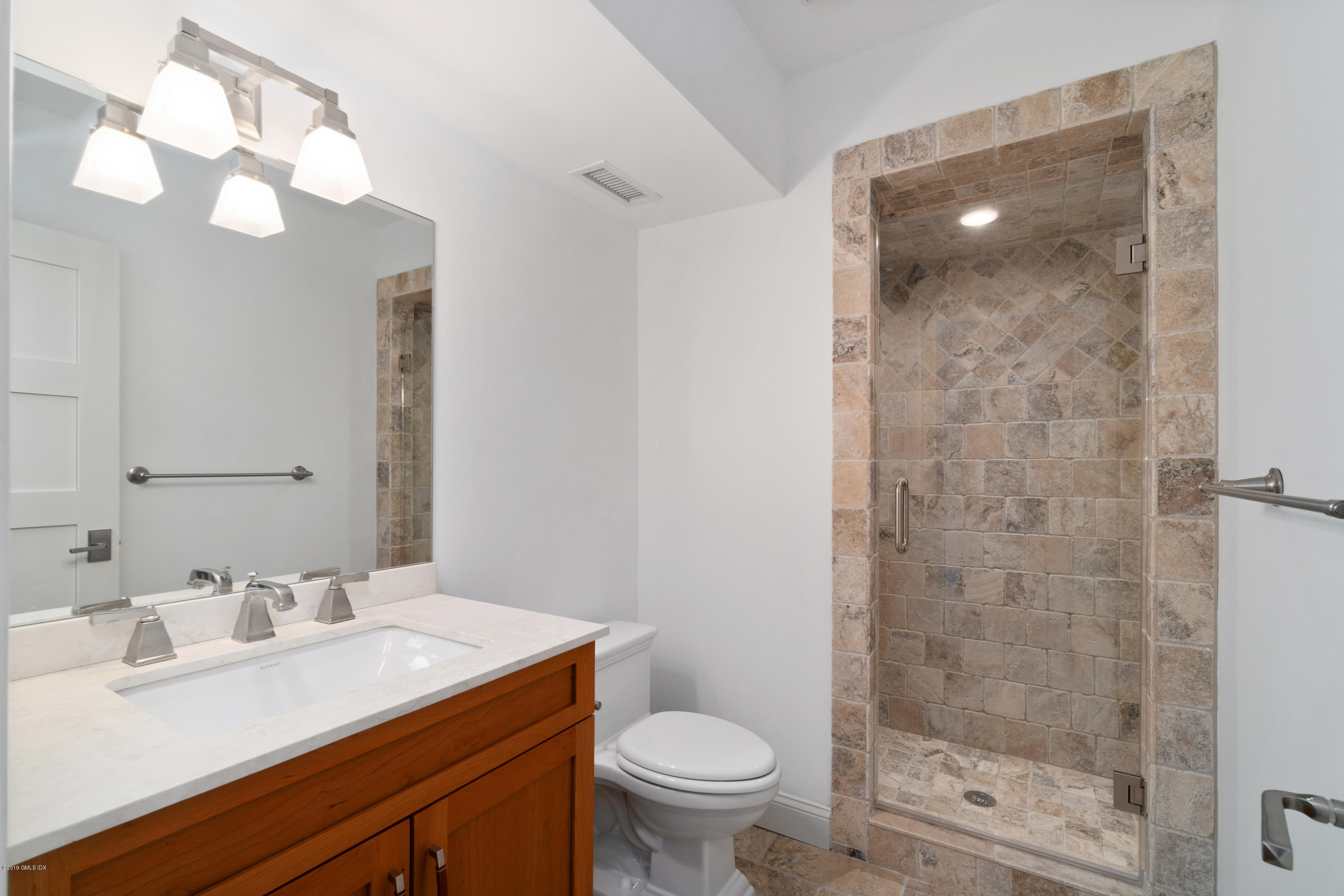 340 Valley Road, Unit 5 Cos Cob, CT 06807 - Photo 18 of 29 a bathroom with a sink a toilet and shower
