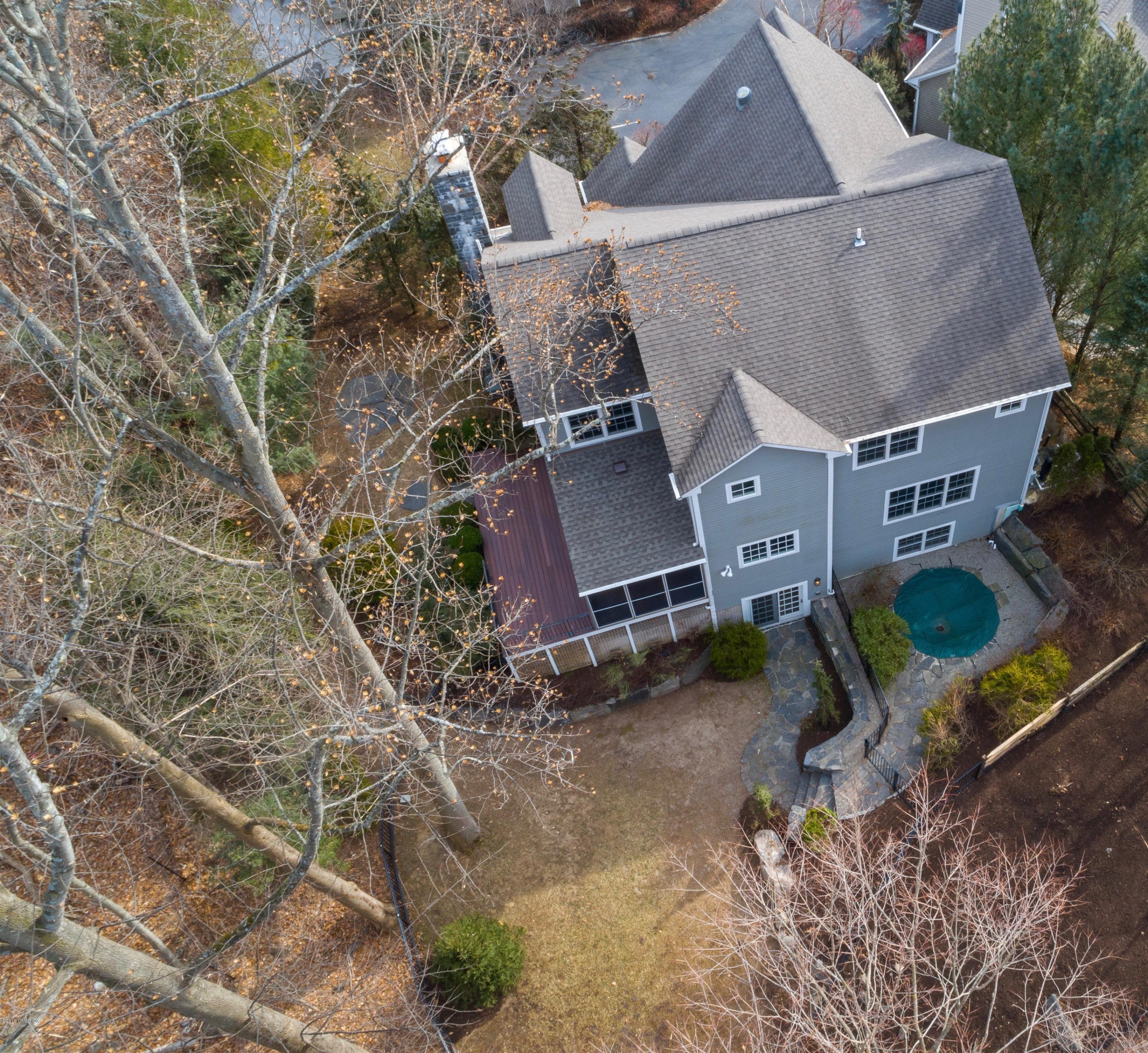 340 Valley Road, Unit 5 Cos Cob, CT 06807 - Photo 2 of 29 an aerial view of a house with a yard and large tree