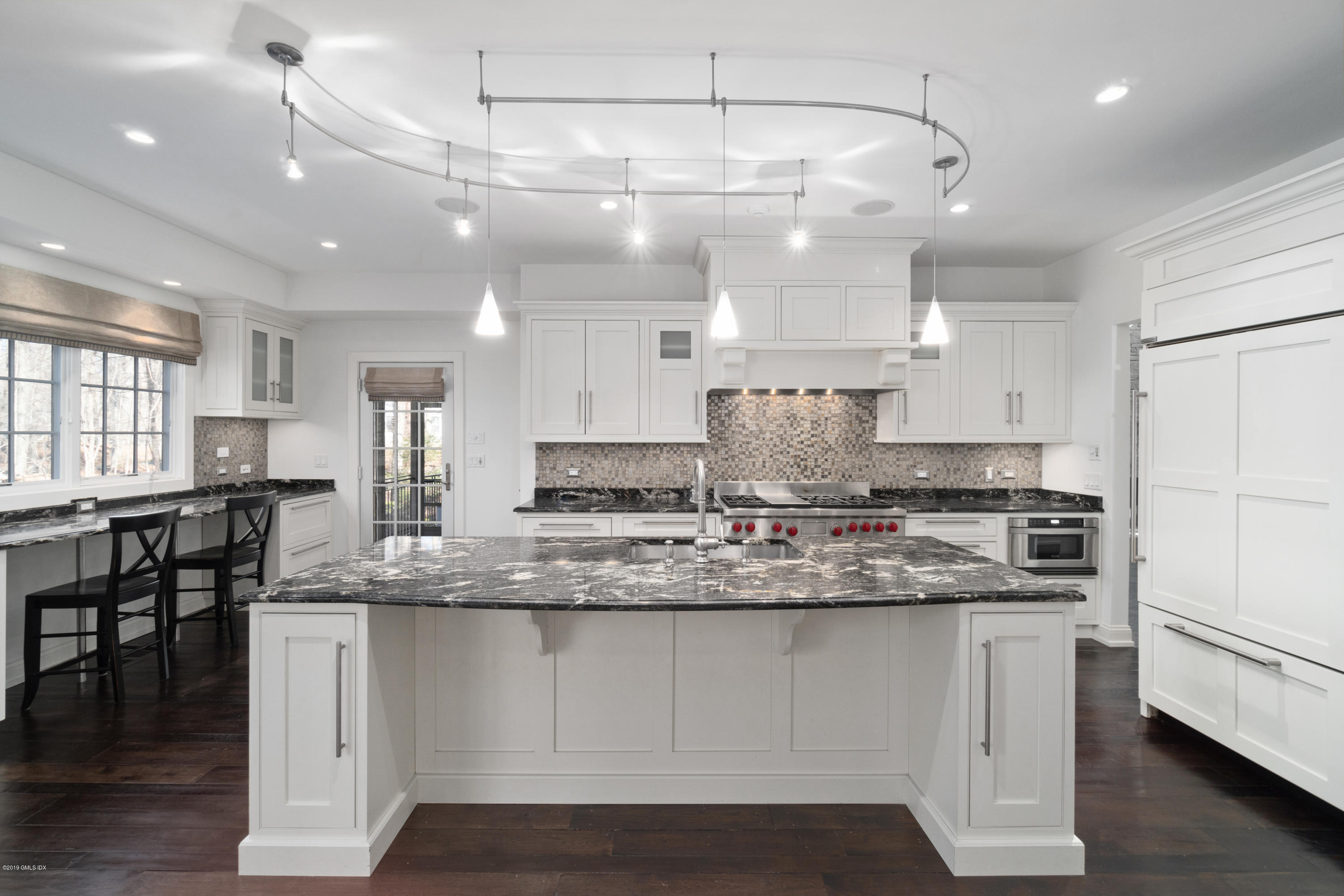 340 Valley Road, Unit 5 Cos Cob, CT 06807 - Photo 6 of 29 a large kitchen with kitchen island a sink a stove a dining table and chairs
