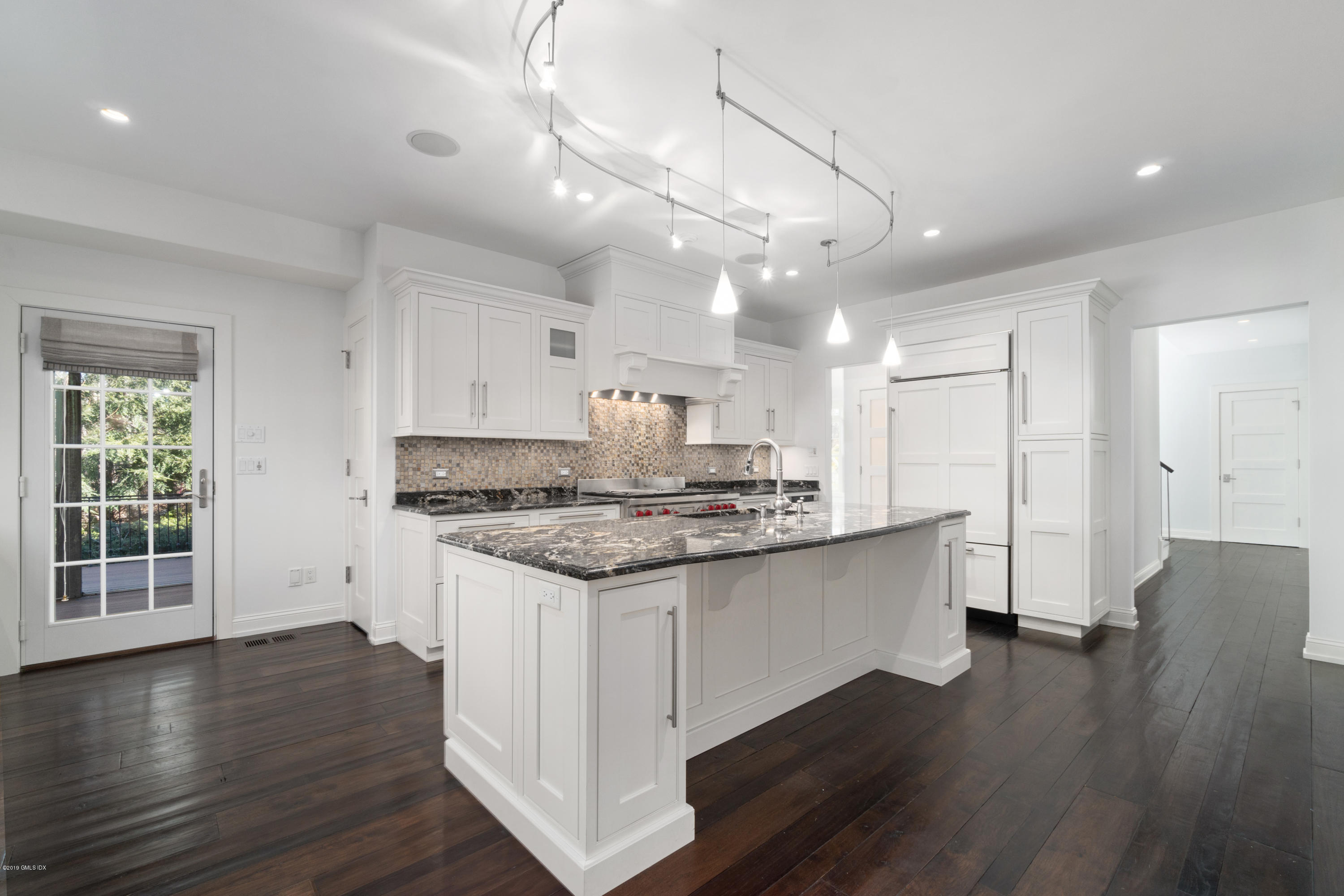 340 Valley Road, Unit 5 Cos Cob, CT 06807 - Photo 7 of 29 a kitchen with stainless steel appliances granite countertop a sink stove and wooden floor