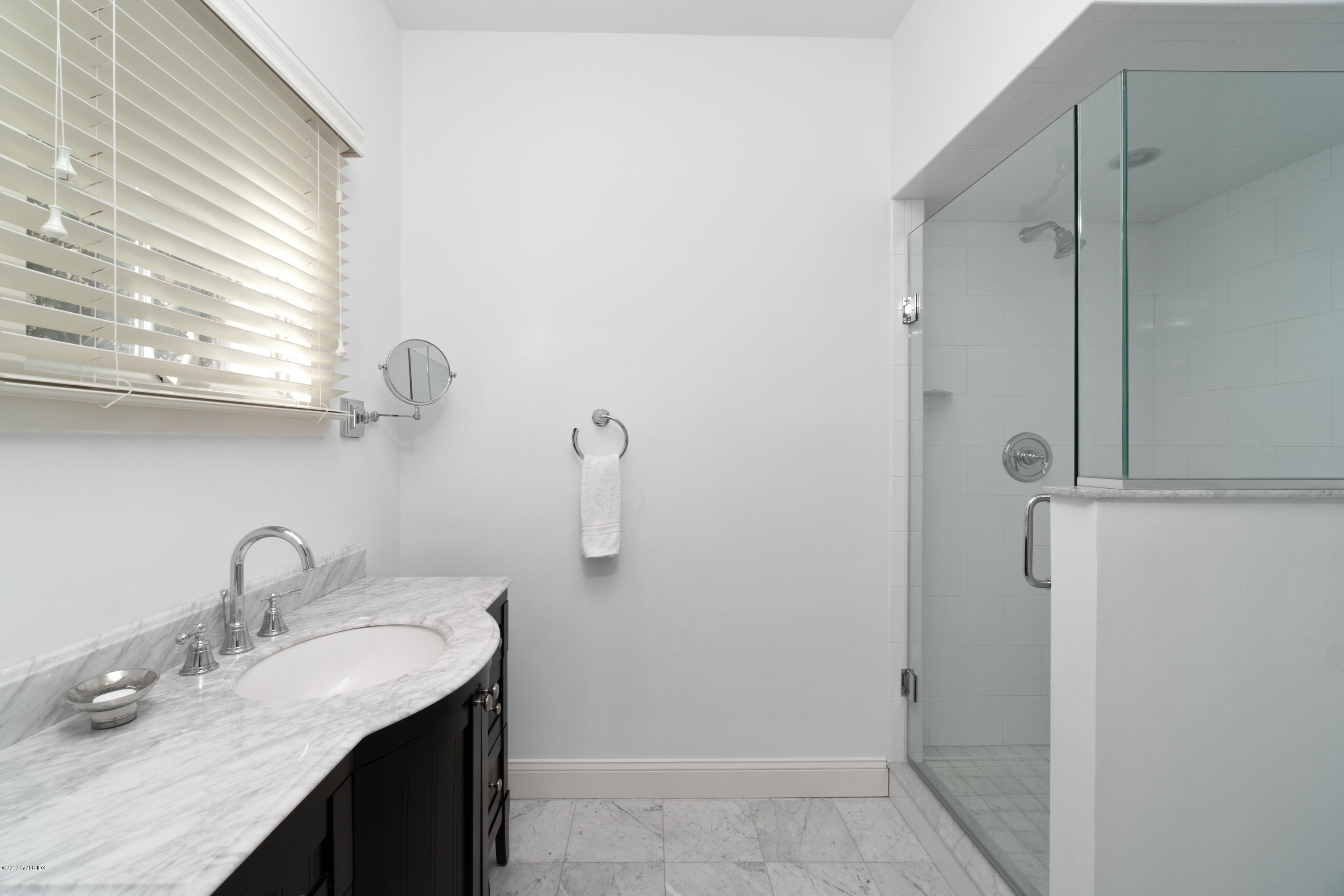 340 Valley Road, Unit 5 Cos Cob, CT 06807 - Photo 9 of 29 a bathroom with a granite countertop sink and a mirror