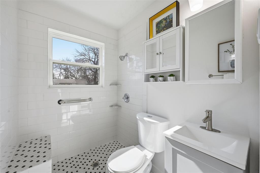 413 Wanda Way Hurst, TX 76053 - Photo 13 of 26 a white toilet sitting next to a bathroom sink