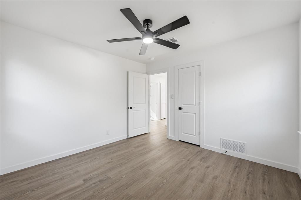 413 Wanda Way Hurst, TX 76053 - Photo 19 of 26 an empty room with wooden floor and ceiling fan