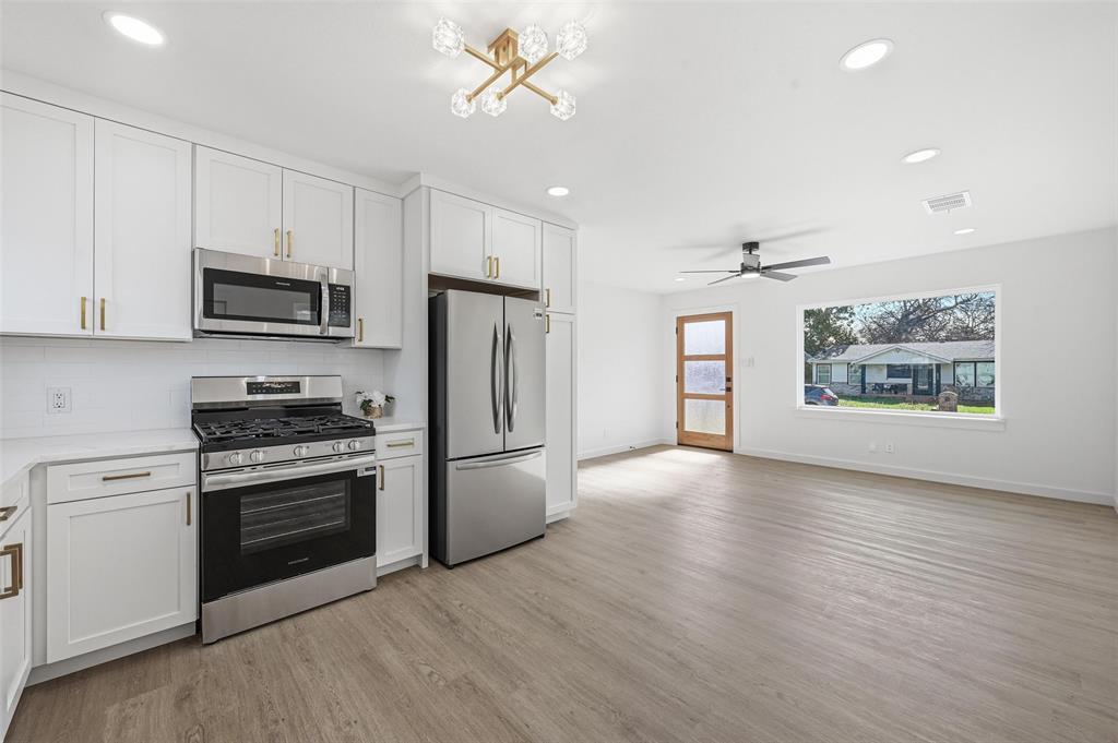 413 Wanda Way Hurst, TX 76053 - Photo 8 of 26 a kitchen with stainless steel appliances a stove a refrigerator and a microwave
