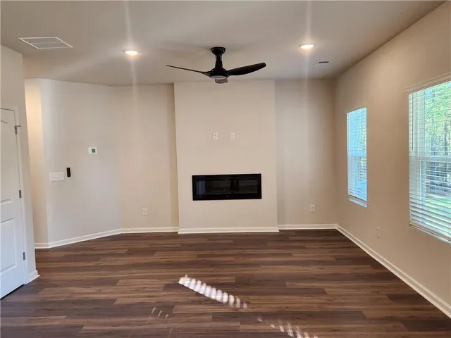 a kitchen with a sink and wooden floor